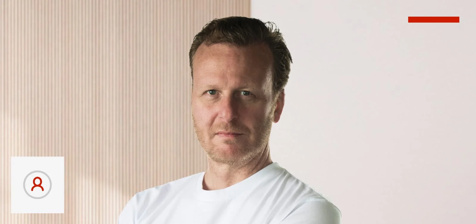 A portrait photo of Alistair against a slightly out-of-focus office background